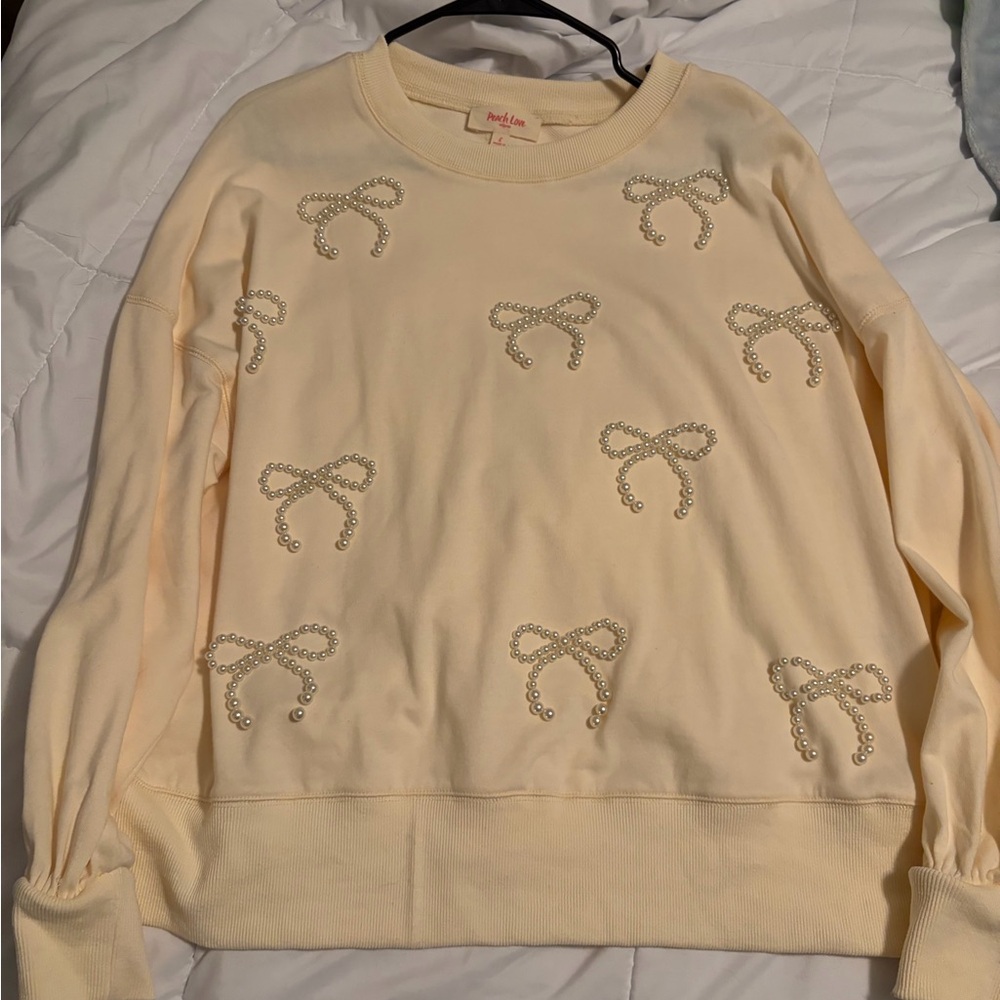 Cream Sweatshirt with Bow Embellishments